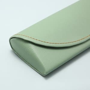 A portable PU sunglasses case in a light green colour, featuring a curved flap and stitching detail.