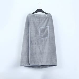 A grey adjustable bath towel wrap with snaps and a pocket, displayed on a hanger against a plain background.