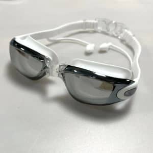 Unisex adult swimming goggles in white and black, featuring a sleek design and adjustable straps.