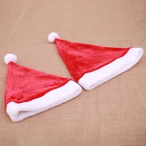 A drink bottle wrap featuring two red Santa hats with white trim and pom-poms. It has a logo on one side.