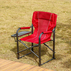 A red camping chair with a side table and bottle holder, featuring a sturdy metal frame.