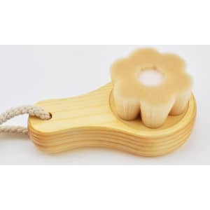 A flower-shaped wooden facial cleansing brush with soft bristles, featuring a natural wood handle and a rope.