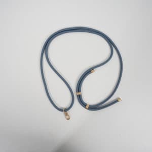 A blue adjustable crossbody lanyard with gold accents and a clip for attaching a cell phone.