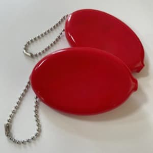 A red PVC oval coin purse with a chain attachment, featuring a smooth, glossy finish.
