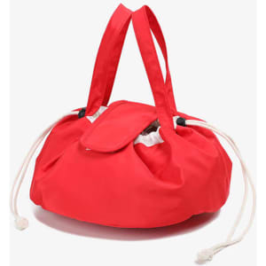 A large red drawstring makeup bag featuring two handles and a cinched opening. It has a logo on the side.