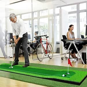 A golf putting green practice mat in vibrant green, designed for indoor use, featuring a flag and golf ball.