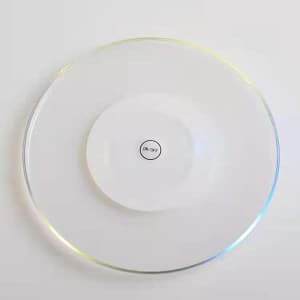 A clear LED coaster with a circular design and a white centre featuring an on/off switch.