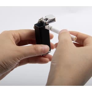 A black portable pocket ashtray with a keychain, held between two hands, featuring a cigarette being extinguished.