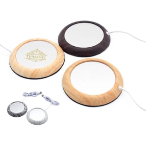 A set of three portable coffee mug warmers in wood, black, and metallic finishes, with charging cables included.