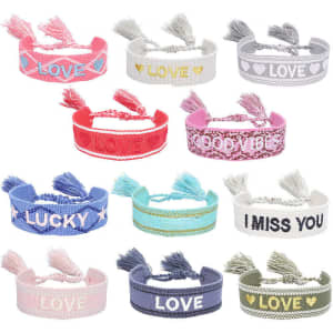 A collection of adjustable embroidery tassel bracelets in various colours, featuring words like "Love," "Lucky," and "Good Vibes."
