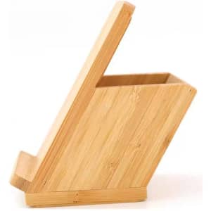 A bamboo pen holder with a slanted design, featuring a natural finish. It has a wireless charging base.