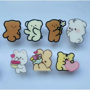 A collection of cute cartoon animal magnets, featuring bears in various poses and a cat holding flowers, in pastel colours.