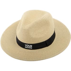 A wide brim Panama hat in straw colour with a black band featuring a logo.