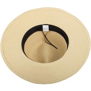 A wide-brimmed straw Panama hat in a light tan colour, featuring a black inner lining and a decorative band.