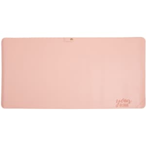 A large pink leather desk mat with a smooth surface and a subtle branding element.