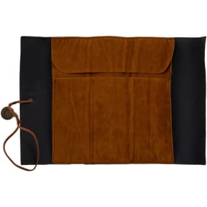 A brown PU leather roll-up pencil case with a flap closure and multiple pockets on a black background.