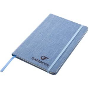 A linen fabric journal notebook in light blue with a blue elastic band and a logo on the front cover.