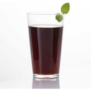 A clear pint glass filled with dark liquid, garnished with a mint leaf on top.