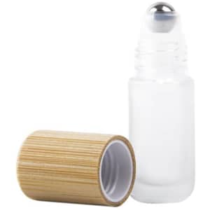 A glass roll-on bottle with a bamboo lid, featuring a silver roller ball and a clear body.