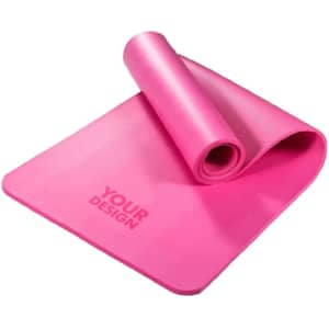 A pink portable non-slip yoga mat, rolled partially with a textured surface, featuring a design area.