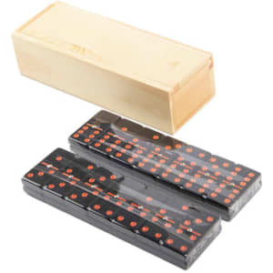 A wooden box containing a set of black dominoes with red dots.
