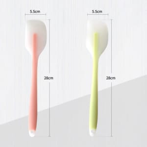 A translucent silicone spatula with a pink and a green handle, measuring 28cm in length and 5.5cm in width.