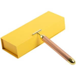 A T Shape electric facial massager in rose gold colour, packaged in a yellow box. The box features a logo.