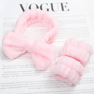 A pink spa headband and matching wrist washbands made of soft, fluffy material, presented on a magazine page.