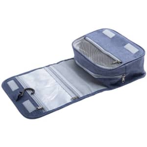 A blue toiletry bag with multiple compartments, mesh pockets, and a hook for hanging. Features branding on the exterior.