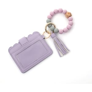 A lilac wallet keychain featuring a tassel and a beaded ring in pastel shades of pink and grey.