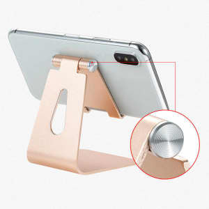 An adjustable aluminium phone and tablet stand in a rose gold finish, displaying a smartphone.