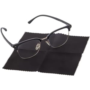 A black microfiber cleaning cloth lies flat beneath a pair of black-rimmed glasses, with a soft texture.