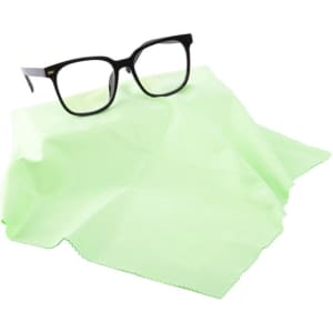 A mint green microfiber lens cloth draped with a pair of black glasses on top, featuring a logo.