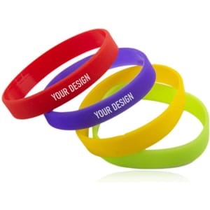 A set of four personalised silicone sport wristbands in red, purple, yellow, and green, featuring a logo.