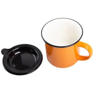 An orange ceramic campfire mug with a black lid and a black base. The mug has a handle and a glossy finish.