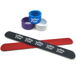 Personalised silicone slap bracelets in red, black, and white, with additional silicone bands in blue and purple.