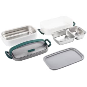 A stainless steel multilayer lunch box in white and grey, featuring green handles. Includes multiple compartments.