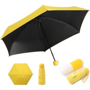 A yellow and black mini UV protective umbrella next to a capsule case for storage. Features a logo on the umbrella.
