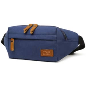 A unisex canvas fanny pack in navy blue with a front zipper pocket and a logo patch. It features brown leather accents.