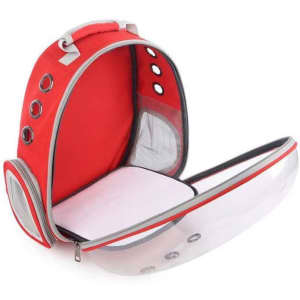 A red pet carrier bubble backpack with a transparent front, mesh sides, and a padded interior. It has a logo.