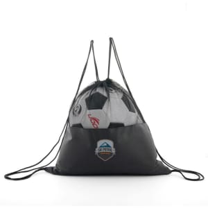 A black mesh drawstring backpack with a logo, holding soccer balls and a sports ball inside.