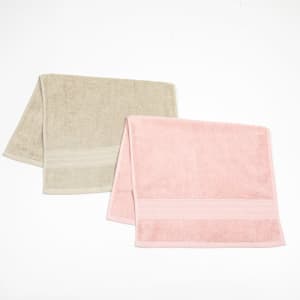 Two hand towels in beige and pink, featuring embroidered detailing and a soft textured finish.