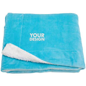A folded sherpa fleece throw blanket in turquoise blue with a white, soft underside and a logo.