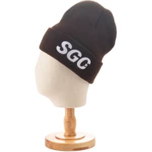 A brown knitted cuffed beanie displayed on a stand, featuring a logo on the front.