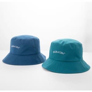 Two bucket hats in blue and teal, featuring a logo on the front.