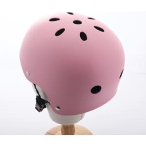 A pink skateboard extreme sports helmet with ventilation holes, displayed on a mannequin head.