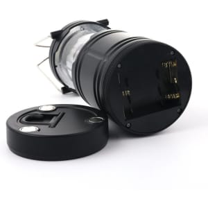A foldable LED camping light in black with a removable base, featuring a sleek, compact design and a logo.