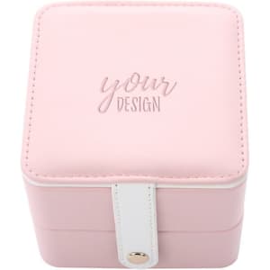 A square, pink mini jewelry box with a white clasp and a logo on the lid.