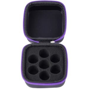 A small black case with a purple zipper, featuring foam cutouts for storing essential oil bottles.