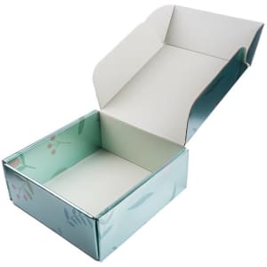 A large eco-friendly paper shipping box in light blue with floral patterns, open and empty.